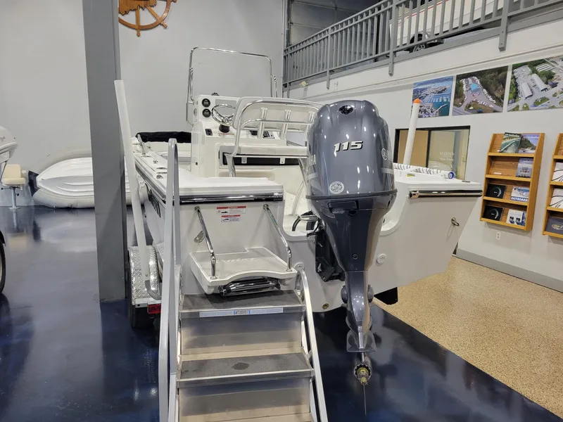 Slide: The Image of 2025 Parker 18 SE CC boat with 115 HP engine displayed indoors. - 4