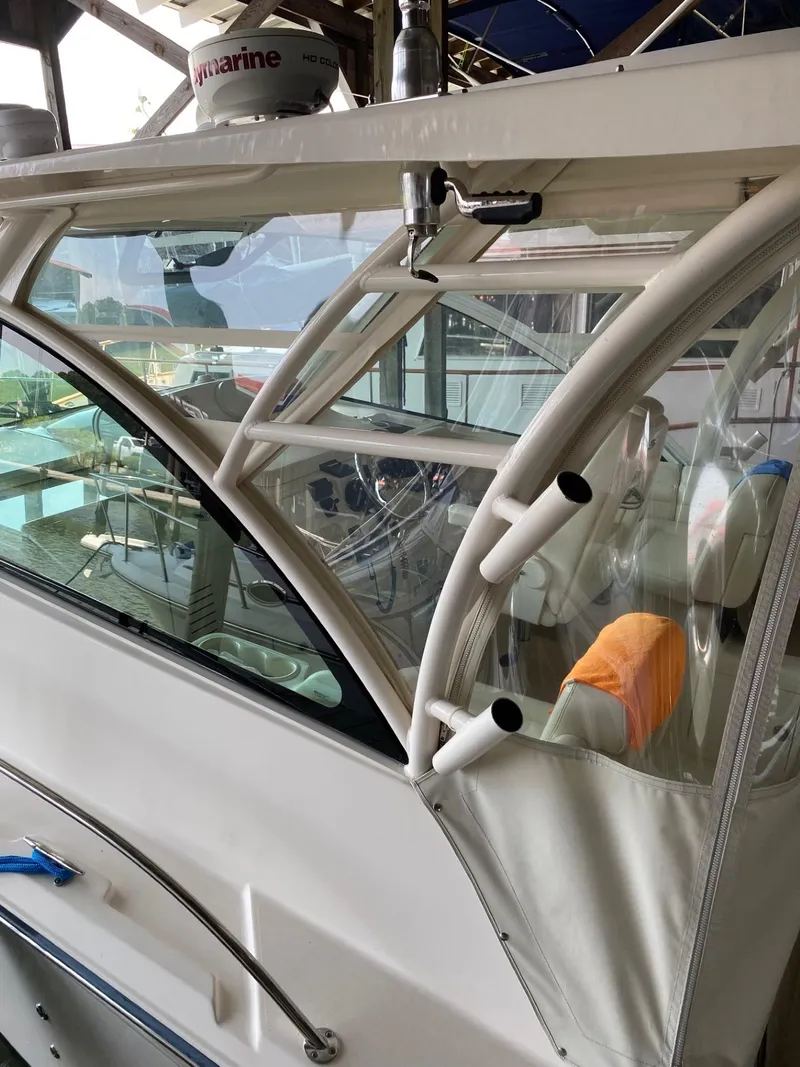 Slide: The Image of 2016 Grady-White 33 Express boat cockpit with Raymarine radar and fishing rod holders. - 6