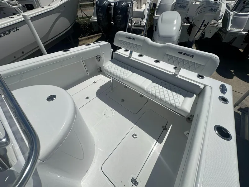 Slide: The Image of 2025 Blue Water 23T CC boat interior with white seating and storage compartments. - 10