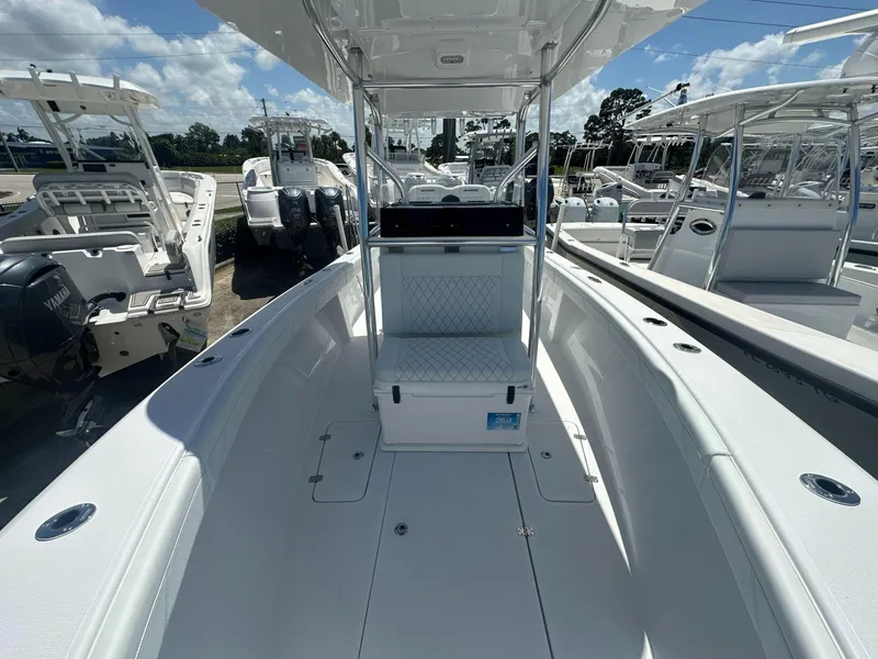 Slide: The Image of 2025 Blue Water 23T CC center console boat with white interior and Yamaha outboard engines. - 7