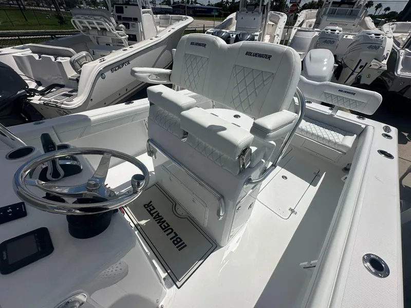 Slide: The Image of 2025 Blue Water 23T CC boat interior with steering wheel and seating - 9