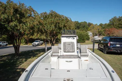 Slide: The Image of 2024 Avid 21 FSX boat on a trailer, parked outdoors near trees and vehicles. - 10