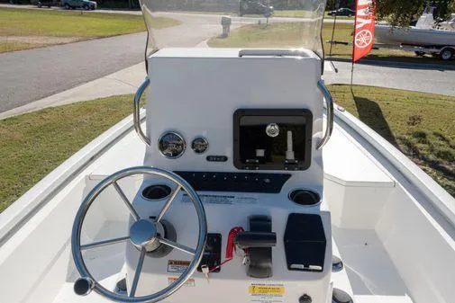Slide: The Image of 2024 Avid 21 FSX boat console with steering wheel and navigation controls. - 13