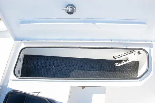 Slide: The Image of Storage compartment of 2024 Avid 21 FSX boat with open lid. - 16