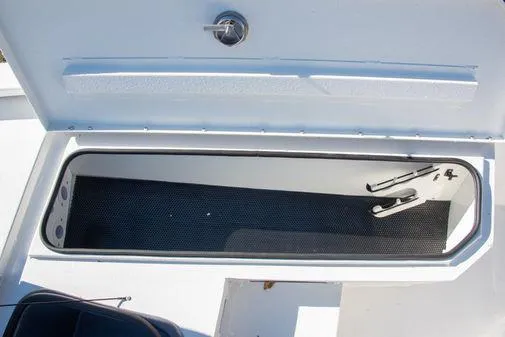 Slide: The Image of Storage compartment of 2024 Avid 21 FSX boat with open lid. - 17