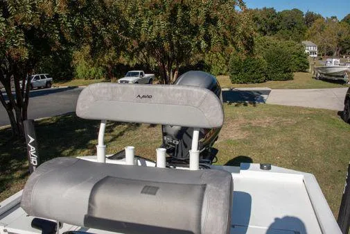 Slide: The Image of 2024 Avid 21 FSX boat with cushioned seating and outboard motor. - 20