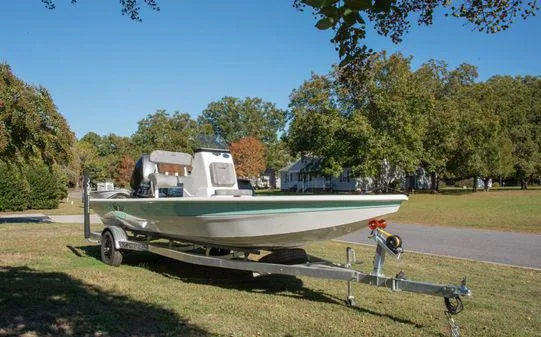 Slide: The Image of 2024 Avid 21 FSX boat on a trailer in a suburban neighborhood. - 24