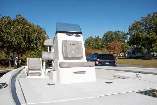 Slide: The Image of 2024 Avid 21 FSX boat with seating and console, parked outdoors. - 5