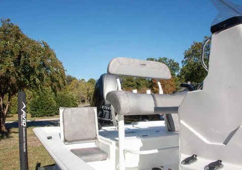 Slide: The Image of 2024 Avid 21 FSX boat with seating and console in a scenic outdoor setting. - 6