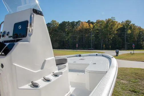 Slide: The Image of 2024 Avid 21 FSX boat with sleek design and modern controls, parked outdoors. - 8