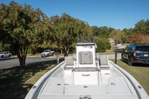 Slide: The Image of 2024 Avid 21 FSX boat parked on a grassy area with trees in the background. - 9