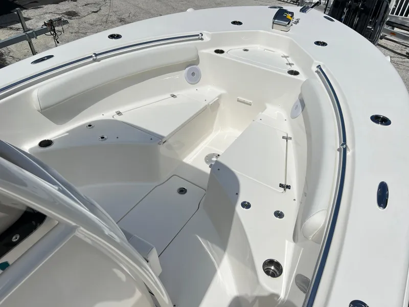 Slide: The Image of 2025 Key West 244 CC boat interior with spacious seating and storage compartments. - 16