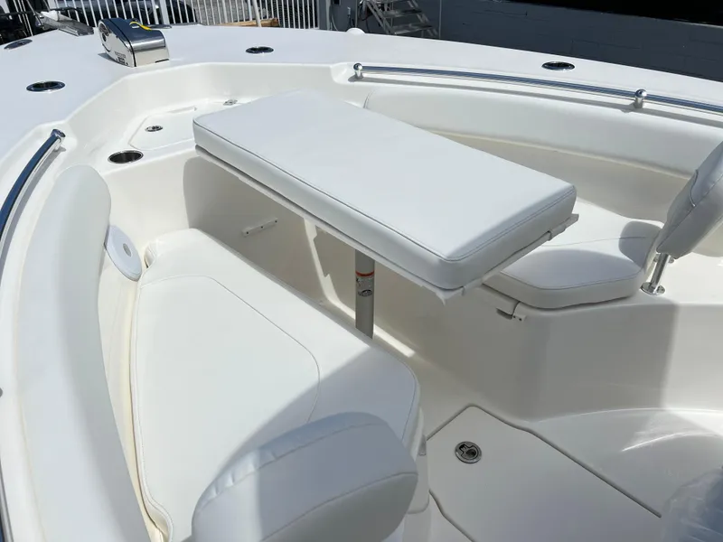 Slide: The Image of 2025 Key West 244 CC boat interior with white seating and table. - 21