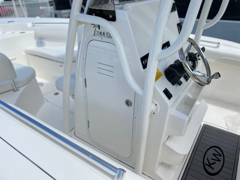 Slide: The Image of 2025 Key West 244 CC center console boat interior with steering wheel and storage. - 28