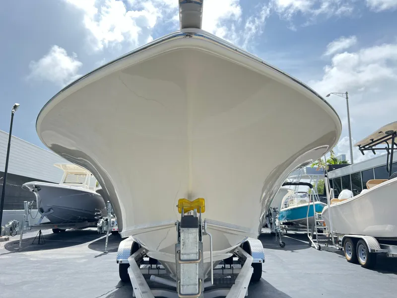 Slide: The Image of 2025 Key West 244 CC boat on trailer, front view under a sunny sky. - 3