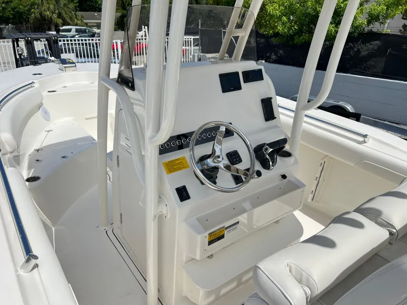 Slide: The Image of 2025 Key West 244 CC center console boat interior with steering wheel and seating. - 34