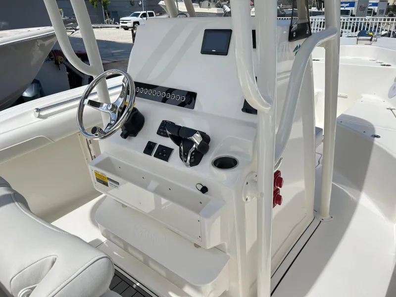 Slide: The Image of 2025 Key West 244 CC center console boat interior with steering wheel and controls. - 36