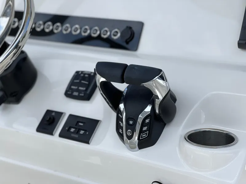 Slide: The Image of 2025 Key West 244 CC boat control panel with throttle and switches. - 38