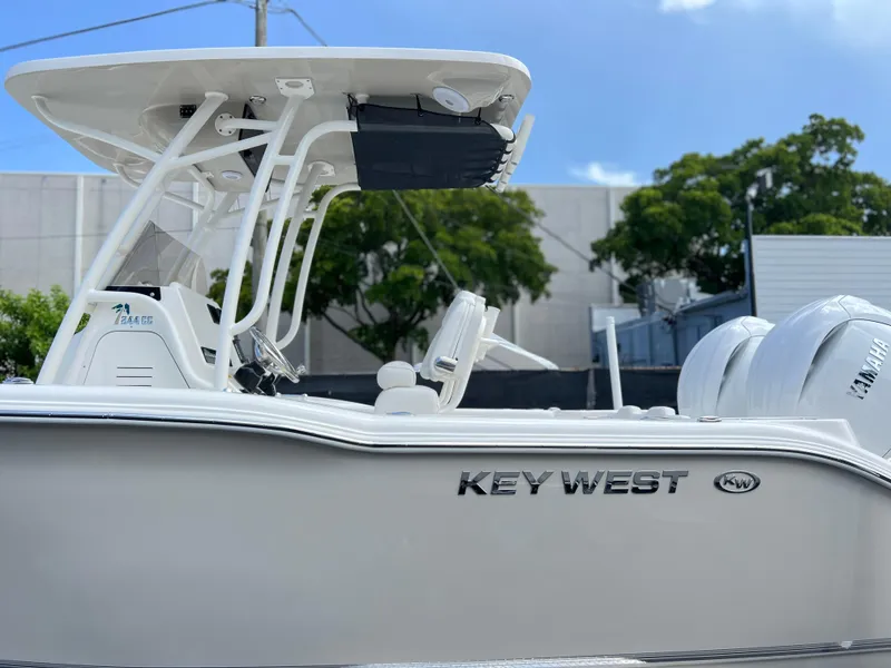 Slide: The Image of 2025 Key West 244 CC boat side view with dual engines and T-top. - 7