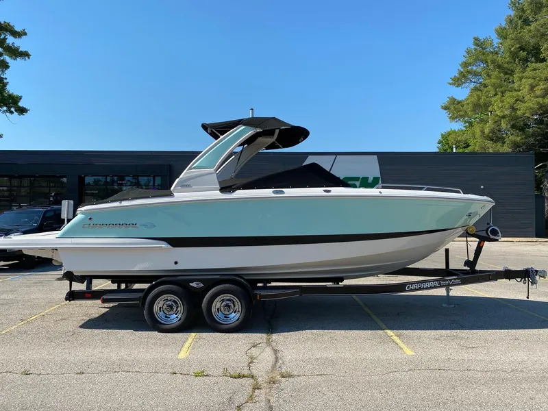 Slide: The Image of 2020 Chaparral 257 SSX boat on a trailer in a parking lot. - 0