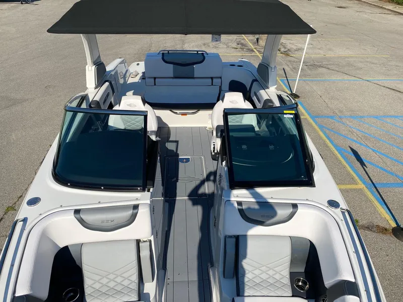 Slide: The Image of 2020 Chaparral 257 SSX boat with black canopy and spacious seating. - 4
