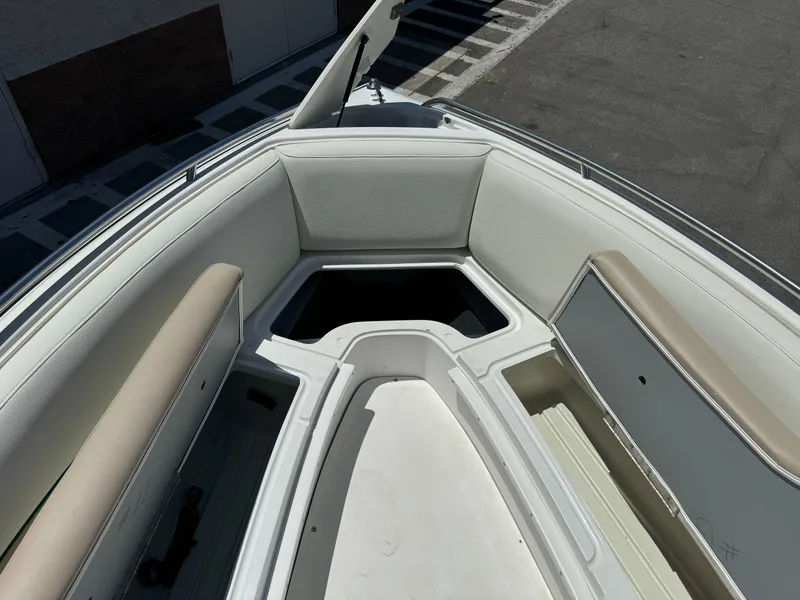 Slide: The Image of 2001 Cobalt 25 LS boat interior with cushioned seating and storage compartments. - 10