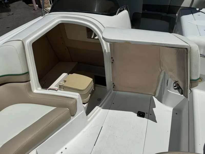Slide: The Image of 2001 Cobalt 25 LS boat interior with seating and storage compartment. - 12