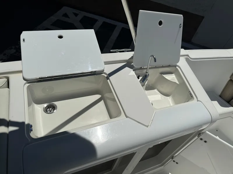 Slide: The Image of 2001 Cobalt 25 LS boat sink and storage compartments. - 17
