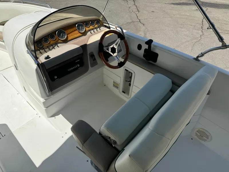 Slide: The Image of 2001 Cobalt 25 LS boat cockpit with steering wheel and control panel. - 18