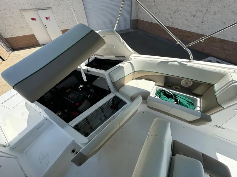 Slide: The Image of 2001 Cobalt 25 LS boat interior with open engine compartment and seating area. - 24