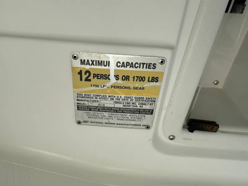 Slide: The Image of 2001 Cobalt 25 LS boat capacity plate, 12 persons or 1700 lbs limit. - 27