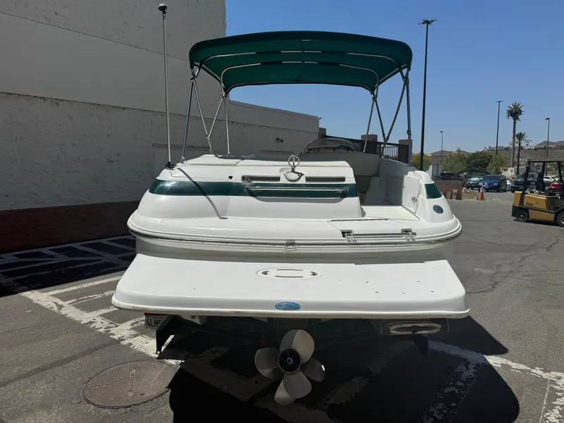 Slide: The Image of 2001 Cobalt 25 LS boat with green canopy in parking lot. - 5