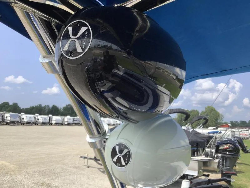 Slide: The Image of Close-up of MB B52 23 boat speakers, 2016 model, under a blue canopy. - 10