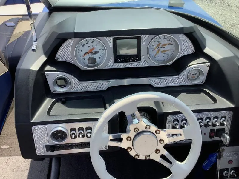 Slide: The Image of 2016 MB B52 23 boat dashboard with steering wheel and control panel. - 12