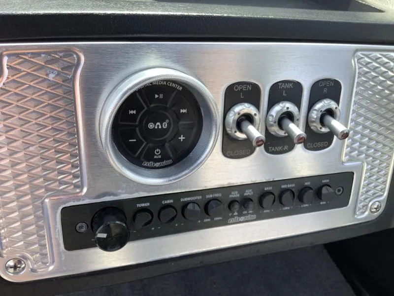 Slide: The Image of Control panel of a 2016 MB B52 23 boat with media center and switches. - 13