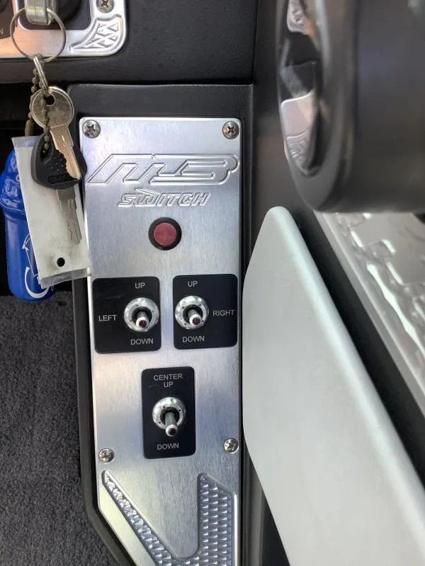 Slide: The Image of Control panel of a 2016 MB B52 23 boat with switches and keys. - 14