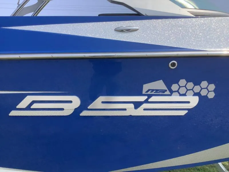 Slide: The Image of 2016 MB B52 23 boat side view with logo and blue paint. - 2
