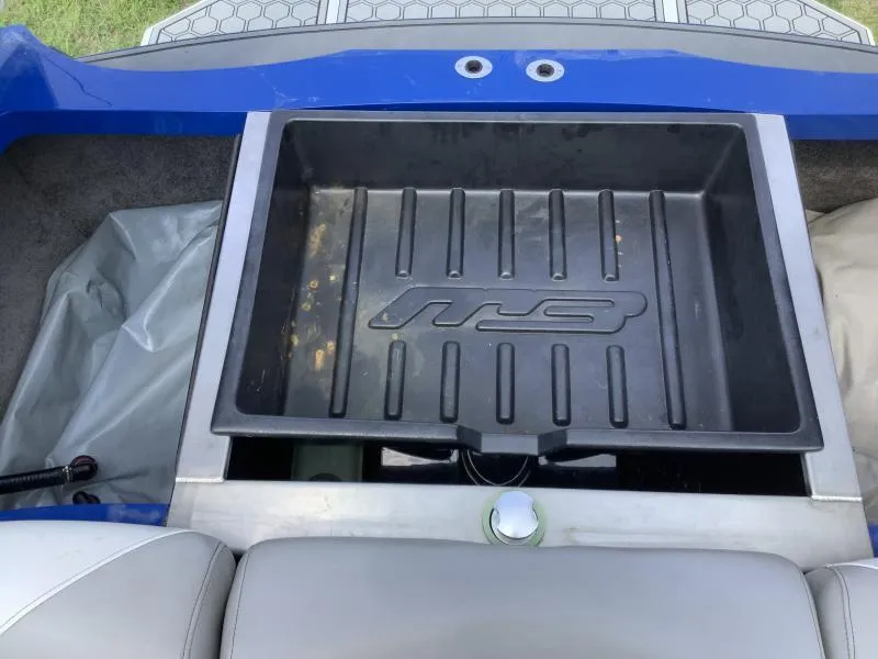 Slide: The Image of 2016 MB B52 23 boat storage compartment with black liner and blue trim. - 20