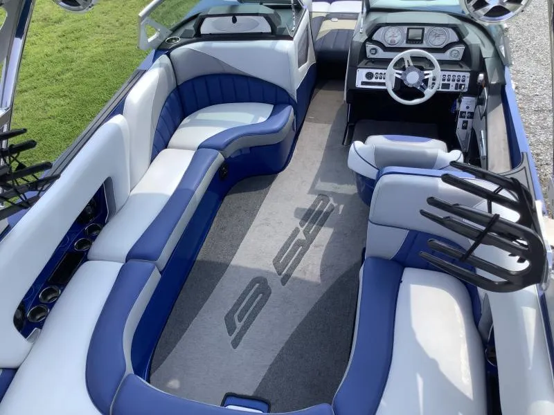 Slide: The Image of Interior of a 2016 MB B52 23 boat with blue and white seating. - 23