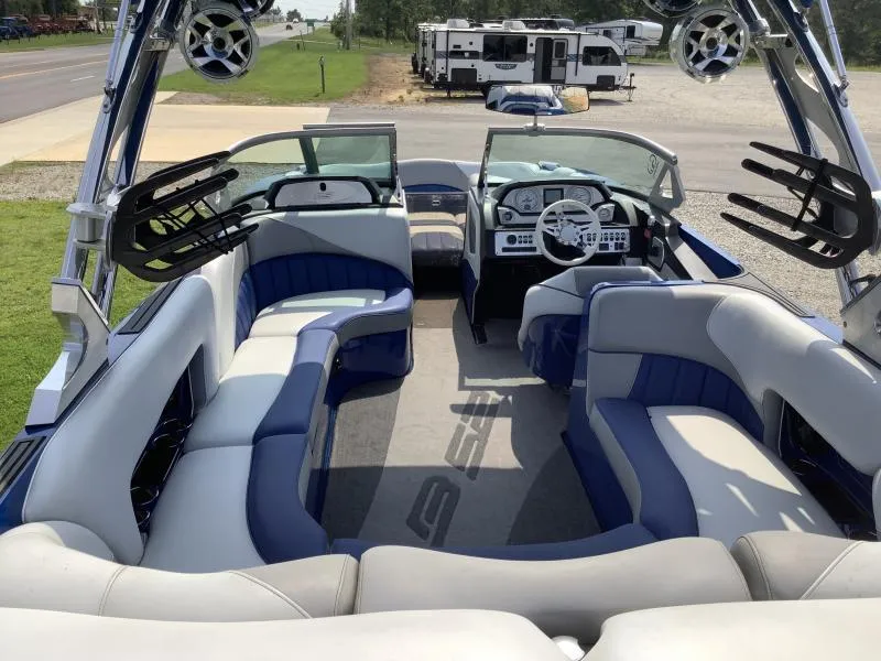 Slide: The Image of 2016 MB B52 23 boat interior with blue and white seating, steering wheel, and dashboard. - 7