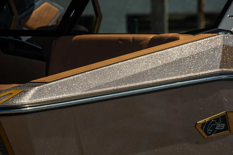 Slide: The Image of 2024 Nautique G23 boat with glittering exterior and luxurious interior. - 13