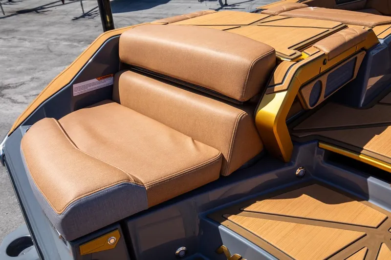Slide: The Image of 2024 Nautique G23 boat with tan leather seating and teak flooring. - 17