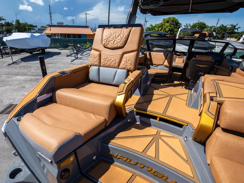 Slide: The Image of 2024 Nautique G23 boat interior with luxurious tan seating and modern design. - 18