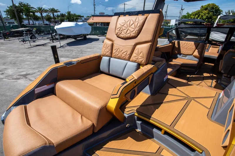 Slide: The Image of 2024 Nautique G23 boat interior with luxurious tan leather seating. - 19