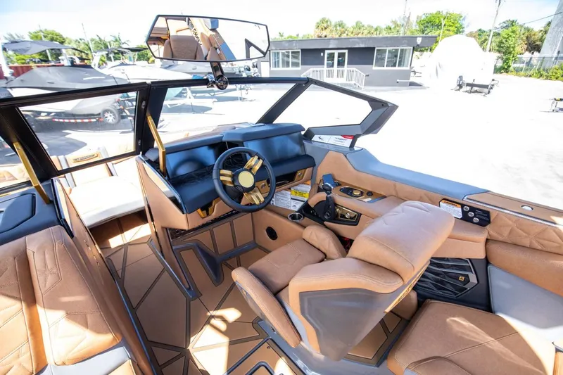 Slide: The Image of 2024 Nautique G23 boat interior with modern dashboard and luxurious seating. - 25