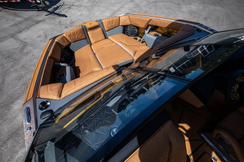 Slide: The Image of 2024 Nautique G23 boat with luxurious tan leather seating. - 26