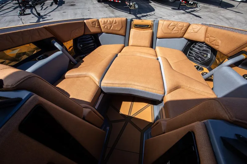 Slide: The Image of 2024 Nautique G23 boat interior with luxurious tan and gray seating. - 27