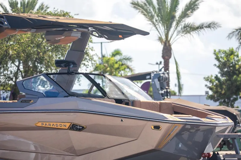 Slide: The Image of 2024 Nautique G23 Paragon boat with sleek design, palm trees in background. - 3