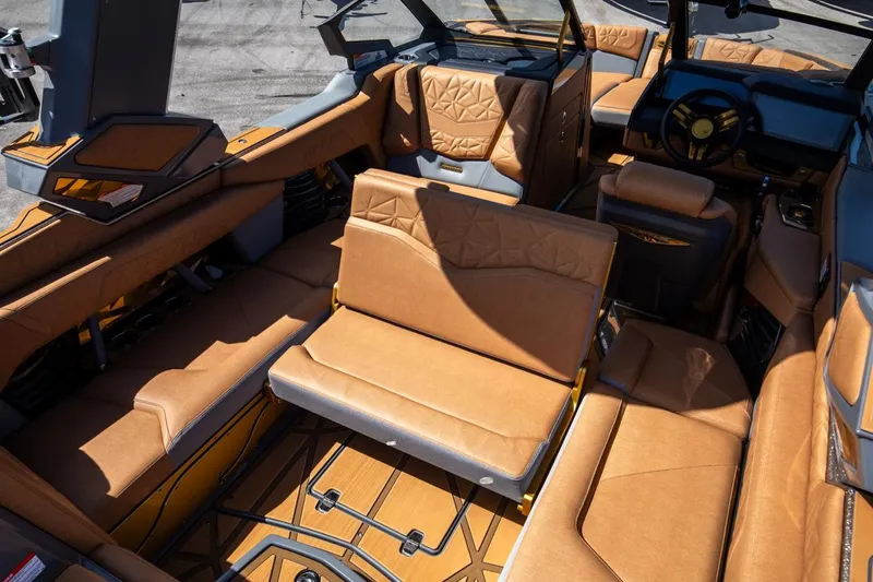 Slide: The Image of 2024 Nautique G23 boat interior with luxurious tan leather seating and modern design. - 32