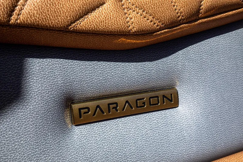 Slide: The Image of 2024 Nautique G23 Paragon interior detail with brown and gray leather upholstery. - 33